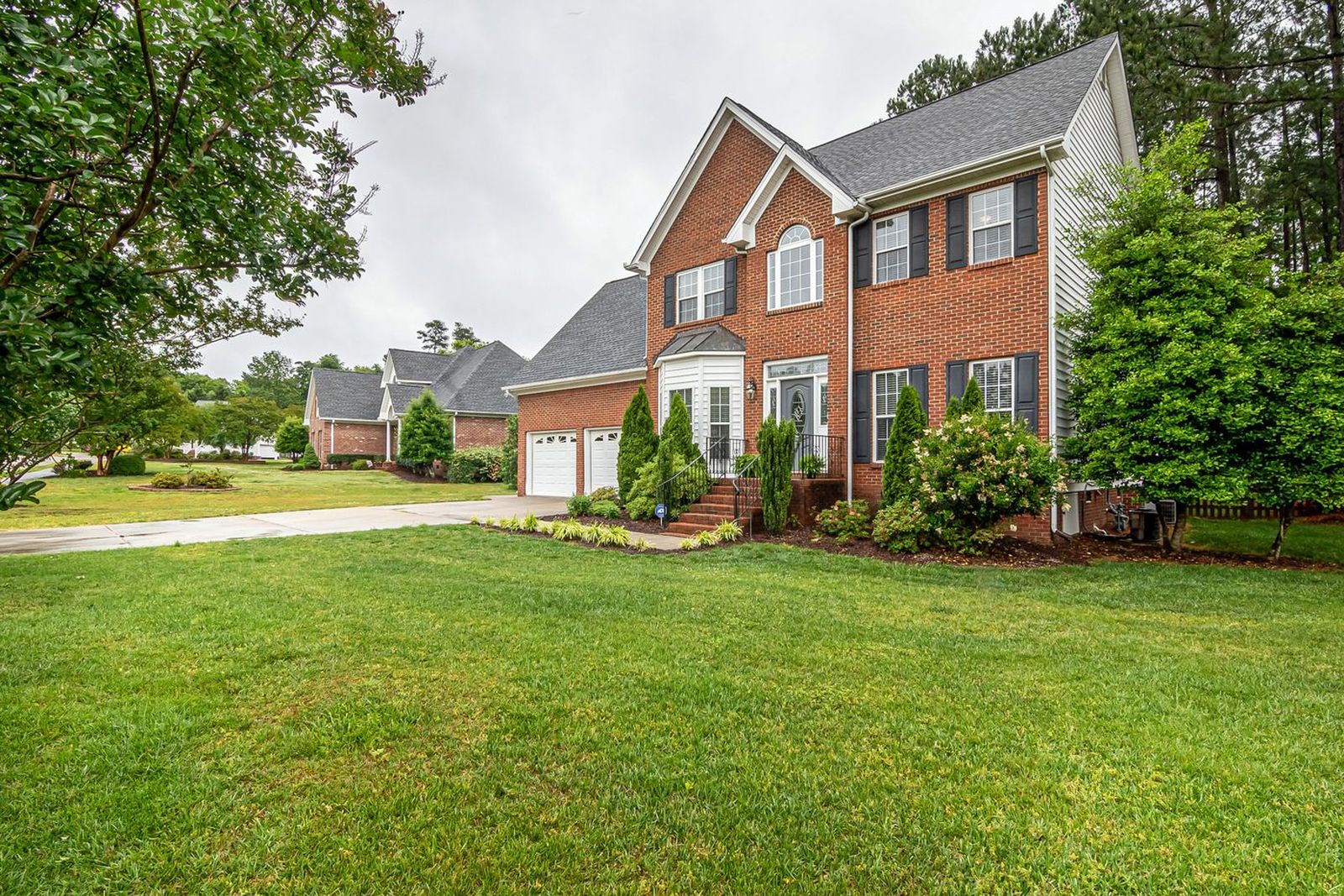 A freshly mown front lawn at a brick house